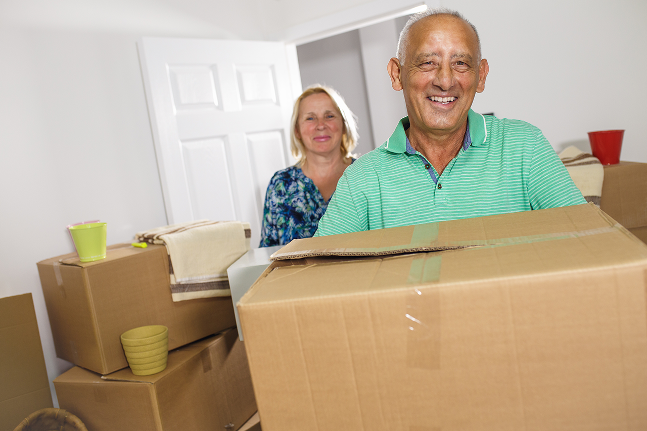 Happy senior couple moving into their new home.