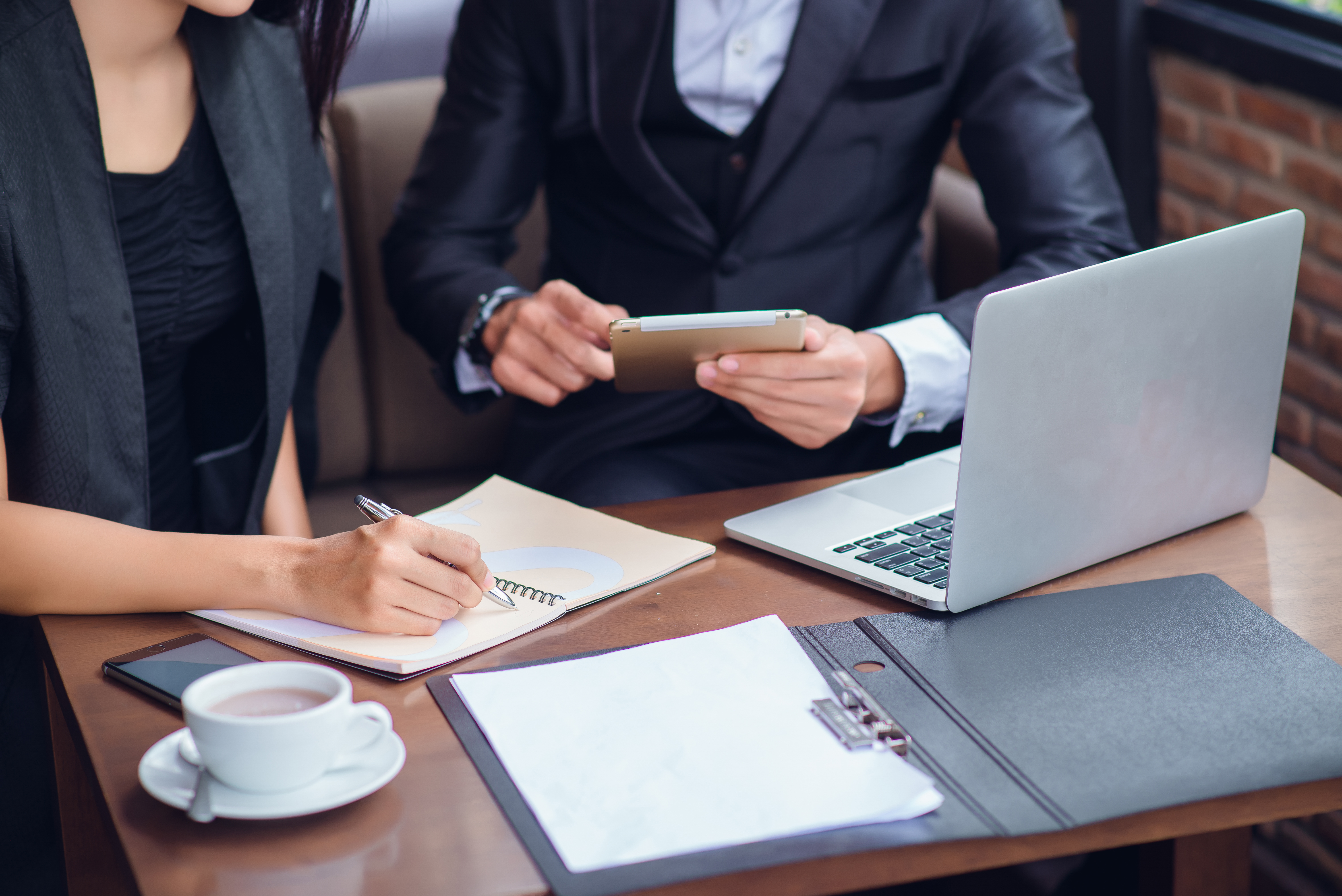 Business woman working at cafe with laptop and documents on his desk